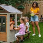 KidKraft Pioneer Cottage Wooden Playhouse – Outdoor Toy for Kids, Playhouse with Porch